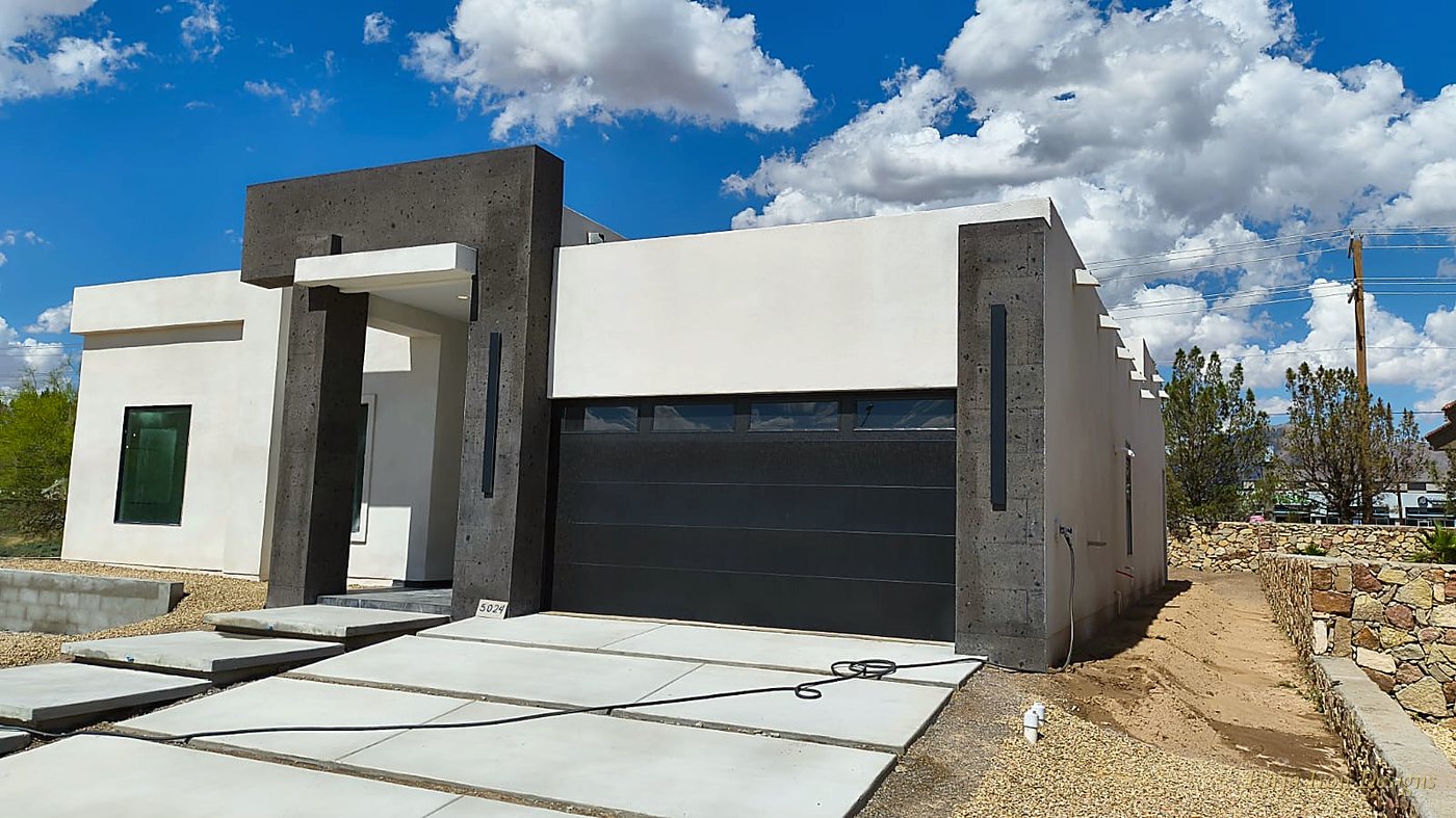 Modern desert hacienda exterior with concrete pillars and custom iron details by Forja Iron Designs