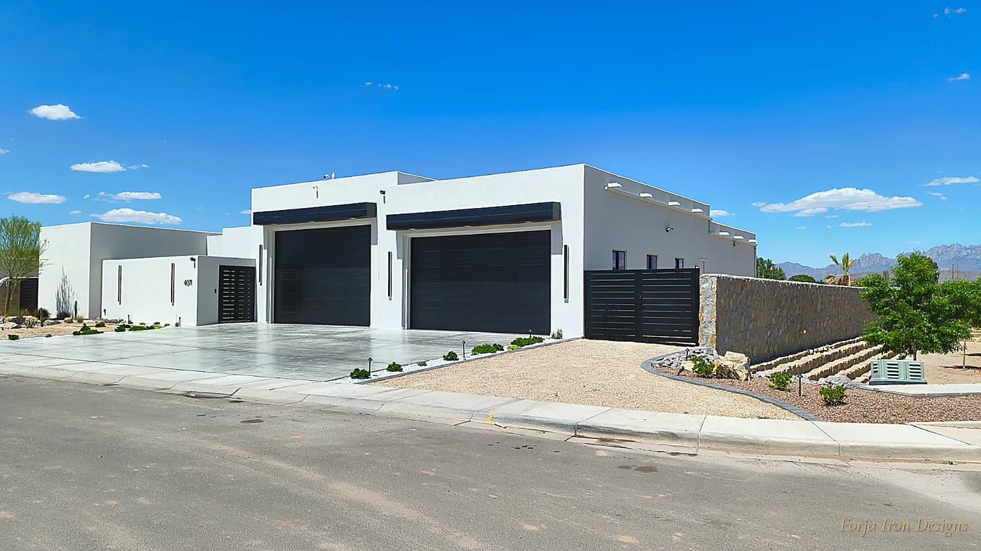Quarry stone perimeter wall with custom black iron slat gate