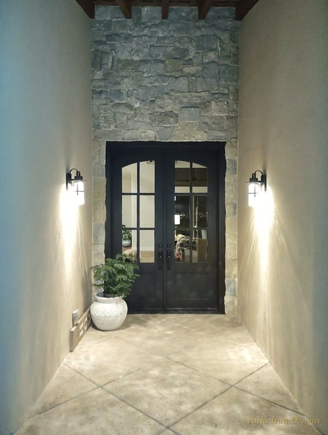 Arched Black Iron Doors in Quarry Stone Surround