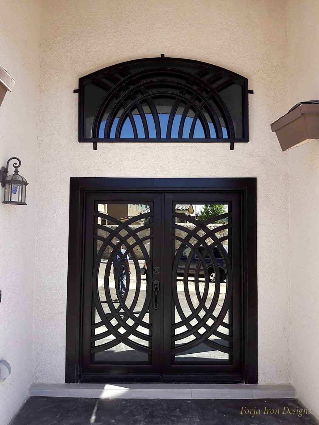Geometric Modern Iron Doors with Arched Transom